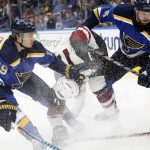 St. Louis Blues defensemen Jay Bouwmeester, left, and Joel Edmundson pressure Arizona Coyotes left wing Brendan Perlini, center, in the second period of an NHL hockey game Saturday, Jan. 20, 2018, in St. Louis. (Chris Lee/St. Louis Post-Dispatch via AP)