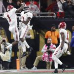 Alabama's Henry Ruggs III is congratulated by Robert Foster (1) after a touchdown catch during the second half of the NCAA college football playoff championship game against Georgia Monday, Jan. 8, 2018, in Atlanta. (AP Photo/David Goldman)