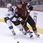 Arizona Coyotes right wing Christian Fischer (36) and San Jose Sharks defenseman Justin Braun battle for the puck in the second period during an NHL hockey game, Tuesday, Jan. 16, 2018, in Glendale, Ariz. (AP Photo/Rick Scuteri)