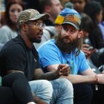 Denver Broncos linebacker Von Miller, left, chats with Colorado Rockies center fielder Charlie Blackmon as they watch the Denver Nuggets play the Phoenix Suns during the second half of an NBA basketball game Friday, Jan. 19, 2018, in Denver. Phoenix won 108-100. (AP Photo/David Zalubowski)