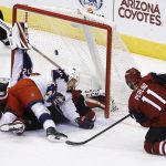 Arizona Coyotes left wing Brendan Perlini (11) shoots over Columbus Blue Jackets left wing Jussi Jokinen (36) to score a goal during the third period of an NHL hockey game Thursday, Jan. 25, 2018, in Glendale, Ariz. The Blue Jackets defeated the Coyotes 2-1. (AP Photo/Ross D. Franklin)