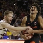 Arizona State guard Kodi Justice (44) ties up the ball with Oregon State guard Ethan Thompson during the first half of an NCAA college basketball game, Saturday, Jan. 13, 2018, in Tempe, Ariz. (AP Photo/Rick Scuteri)