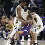 Phoenix Suns' Isaiah Canaan, middle, loses control of the basketball while being defended by Indiana Pacers' Thaddeus Young, left, and Cory Joseph during the first half of an NBA basketball game Wednesday, Jan. 24, 2018, in Indianapolis. (AP Photo/Darron Cummings)