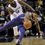 Phoenix Suns guard Troy Daniels, bottom, and Memphis Grizzlies guard Tyreke Evans (12) struggle for control of the ball in the second half of an NBA basketball game Monday, Jan. 29, 2018, in Memphis, Tenn. (AP Photo/Brandon Dill)