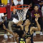 Arizona State guard Remy Martin, left, shoots against Oregon guard Victor Bailey Jr. (10) and forward Kenny Wooten, right, during the second half of an NCAA college basketball game Thursday, Jan. 11, 2018, in Tempe, Ariz. Oregon defeated Arizona State 76-72. (AP Photo/Ross D. Franklin)