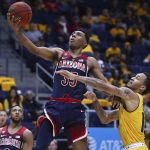 Arizona's Allonzo Trier, left, lays up a shot past California's Don Coleman in the second half of an NCAA college basketball game Wednesday, Jan. 17, 2018, in Berkeley, Calif. (AP Photo/Ben Margot)