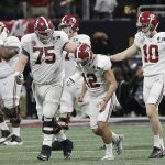 Alabama place kicker Andy Pappanastos is consoled after missing a field goal during the second half of the NCAA college football playoff championship game against Georgia Monday, Jan. 8, 2018, in Atlanta. (AP Photo/David J. Phillip)