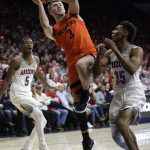 Oregon State forward Tres Tinkle (3) shoots over Arizona guard Allonzo Trier in the first half during an NCAA college basketball game, Thursday, Jan. 11, 2018, in Tucson, Ariz. (AP Photo/Rick Scuteri)