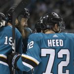 San Jose Sharks center Joe Thornton (19) is congratulated by teammates, including Tim Heed (72), after scoring a goal against the Arizona Coyotes during the first period of an NHL hockey game Saturday, Jan. 13, 2018, in San Jose, Calif. (AP Photo/Tony Avelar)