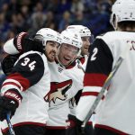 Arizona Coyotes' Zac Rinaldo (34) is congratulated by teammates Max Domi (16) and Luke Schenn (2) after scoring during the first period of an NHL hockey game against the St. Louis Blues, Saturday, Jan. 20, 2018, in St. Louis. (AP Photo/Jeff Roberson)
