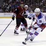 New York Rangers left wing Jimmy Vesey (26) carries the puck past Arizona Coyotes center Nick Cousins in the first period during an NHL hockey game, Saturday, Jan. 6, 2018, in Glendale, Ariz. (AP Photo/Rick Scuteri)