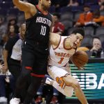 Phoenix Suns guard Devin Booker (1) is fouled by Houston Rockets guard Eric Gordon (10) during the second half of an NBA basketball game, Friday, Jan. 12, 2018, in Phoenix. (AP Photo/Matt York)