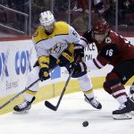 Nashville Predators right wing Craig Smith (15) and Arizona Coyotes left wing Max Domi vie for the puck during the first period of an NHL hockey game, Thursday, Jan. 4, 2018, in Glendale, Ariz. (AP Photo/Rick Scuteri)