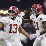 Alabama quarterback Tua Tagovailoa congratulates Henry Ruggs III (11) after his touchdown catch during the second half of the NCAA college football playoff championship game against Georgia, Monday, Jan. 8, 2018, in Atlanta. (AP Photo/David J. Phillip)