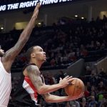 Portland Trail Blazers guard Shabazz Napier, right, shoots over Phoenix Suns guard Troy Daniels during the first half of an NBA basketball game in Portland, Ore., Tuesday, Jan. 16, 2018. (AP Photo/Craig Mitchelldyer)