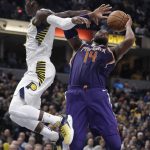 Phoenix Suns' Greg Monroe is fouled by Indiana Pacers' Victor Oladipo as he goes up for a shot during the second half of an NBA basketball game Wednesday, Jan. 24, 2018, in Indianapolis. The Pacers won 116-101. (AP Photo/Darron Cummings)