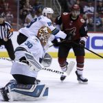 San Jose Sharks goaltender Aaron Dell (30) makes the save as Joe Thornton (19) shields Arizona Coyotes left wing Brendan Perlini (11) in the third period during an NHL hockey game, Tuesday, Jan. 16, 2018, in Glendale, Ariz. San Jose defeated Arizona 3-2 in an overtime shootout. (AP Photo/Rick Scuteri)