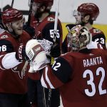 Arizona Coyotes right wing Christian Fischer (36) celebrates with Antti Raanta (32) after scoring in overtime against the Nashville Predators during an NHL hockey game, Thursday, Jan. 4, 2018, in Glendale, Ariz. The Coyotes won 3-2. (AP Photo/Rick Scuteri)