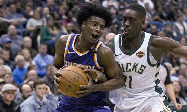 Phoenix Suns forward Josh Jackson, left, is defended by Milwaukee Bucks guard Tony Snell, right, du...