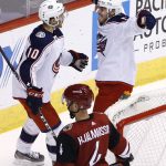 Columbus Blue Jackets right wing Cam Atkinson, top right, celebrates his goal with center Alexander Wennberg (10) as Arizona Coyotes defenseman Niklas Hjalmarsson (4) skates past during the third period of an NHL hockey game, Thursday, Jan. 25, 2018, in Glendale, Ariz. The Blue Jackets defeated the Coyotes 2-1. (AP Photo/Ross D. Franklin)