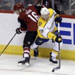 Nashville Predators center Colton Sissons (10) clears the puck from Arizona Coyotes left wing Max Domi during the second period during an NHL hockey game Thursday, Jan. 4, 2018, in Glendale, Ariz. (AP Photo/Rick Scuteri)