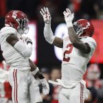 Alabama's Tony Brown celebrates with Ronnie Harrison (15) after intercepting a pass during the first half of the NCAA college football playoff championship game against Georgia Monday, Jan. 8, 2018, in Atlanta. (AP Photo/David J. Phillip)
