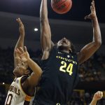 Oregon forward Abu Kigab (24) grabs a rebound from Arizona State guard Tra Holder (0) during the first half of an NCAA college basketball game, Thursday, Jan. 11, 2018, in Tempe, Ariz. (AP Photo/Ross D. Franklin)