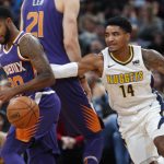 Phoenix Suns guard Troy Daniels, left, loses control of the ball as Denver Nuggets guard Gary Harris defends in the first half of an NBA basketball game Wednesday, Jan. 3, 2018, in Denver. (AP Photo/David Zalubowski)