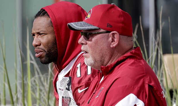 Arizona Cardinals head coach Bruce Arians and Larry Fitzgerald watch players during an NFL football...