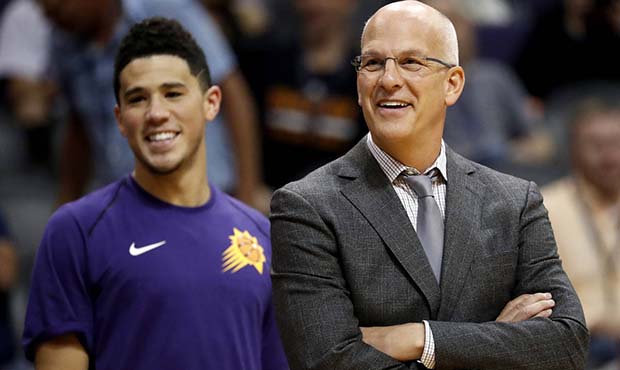 Phoenix Suns head coach Jay Triano and guard Devin Booker smile during the second half of an NBA ba...