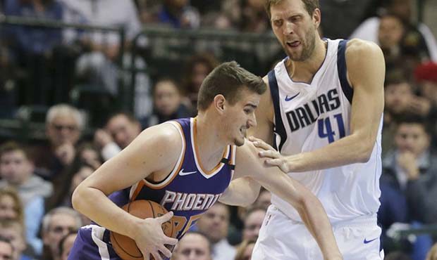 Phoenix Suns forward Dragan Bender (35) drives against Dallas Mavericks forward Dirk Nowitzki (41) ...