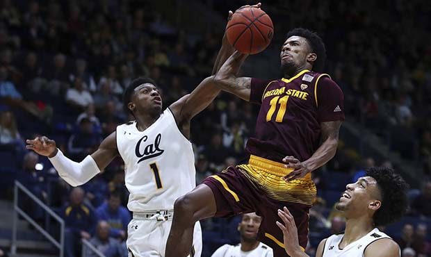 Arizona State's Shannon Evans II (11) shoots between California's Darius McNeill, left, and Justice...