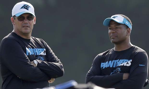Carolina Panthers head coach Ron Rivera, left, talks with assistant head coach Steve Wilks, right, ...