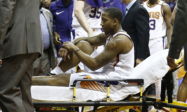 Phoenix Suns guard Isaiah Canaan is taken off the court due to injury during the first half of an N...