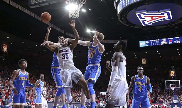 Arizona guard Allonzo Trier (35) loses the ball as he drives to the basket between UCLA's Thomas We...
