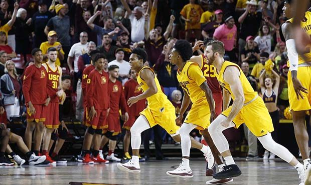 Arizona State's Mickey Mitchell, right, Shannon Evans II, middle, and guard Tra Holder, left, celeb...