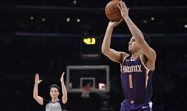 Phoenix Suns' Devin Booker shoots during the NBA basketball All-Star weekend 3-Point contest, Satur...