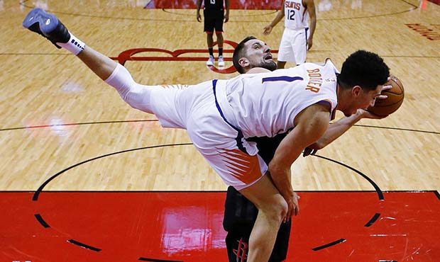 Phoenix Suns guard Devin Booker (1) fouls Houston Rockets forward Ryan Anderson during the second h...