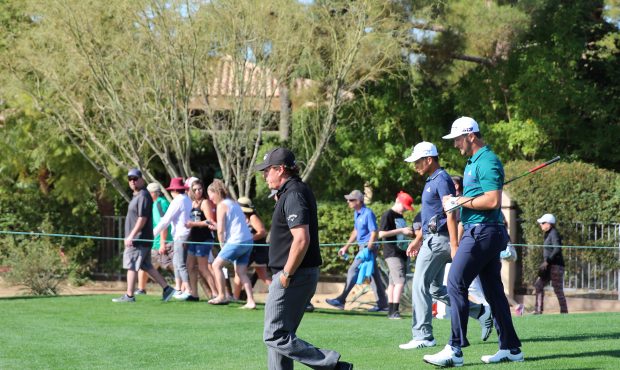 Phil MIckelson, left, and Jon Rahm head to their next shot with 	Xander Schauffele. (Photo by Katie...