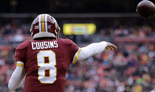 Washington Redskins quarterback Kirk Cousins (8) throws to running back Samaje Perine (32) during a...