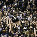 Fans hoist Washington mascot Harry the Husky after the team's 78-75 win over Arizona in an NCAA college basketball game Saturday, Feb. 3, 2018, in Seattle. (AP Photo/John Froschauer)