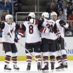 Arizona Coyotes defenseman Alex Goligoski, second from right, celebrates with teammates after scoring a goal against the San Jose Sharks during the second period of an NHL hockey game in San Jose, Calif., Tuesday, Feb. 13, 2018. (AP Photo/Jeff Chiu)