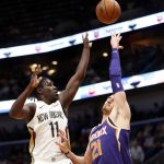 New Orleans Pelicans guard Jrue Holiday (11) shoots over Phoenix Suns center Alex Len (21) in the first half of an NBA basketball game in New Orleans, Monday, Feb. 26, 2018. (AP Photo/Gerald Herbert)
