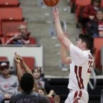 Washington State guard Carter Skaggs, right, shoots over Arizona State guard Tra Holder, obscured, during the second half of an NCAA college basketball game in Pullman, Wash., Sunday, Feb. 4, 2018. (AP Photo/Young Kwak)