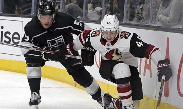 Arizona Coyotes right winger Josh Archibald (45) reaches for the puck ahead of Los Angeles Kings de...