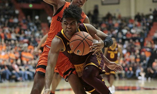 Arizona State's Remy Martin, front, is fouled by Oregon State's Ethan Thompson, rear, in the second...