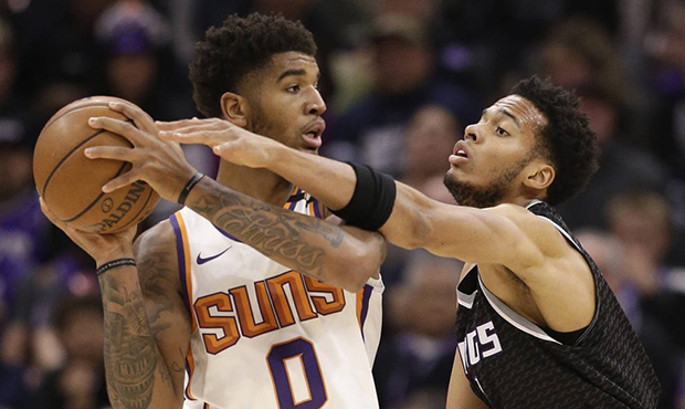 Phoenix Suns forward Marquese Chriss, left, keeps the ball away from Sacramento Kings forward Skal ...