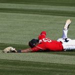 Cincinnati Reds outfielder Phillip Ervin (27) dives in vain for a double hit by Arizona Diamondbacks' Nick Ahmed during the fifth inning of a spring training baseball game Monday, Feb. 26, 2018, in Goodyear, Ariz. (AP Photo/Ross D. Franklin)