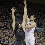 Arizona's Dusan Ristic shoots over Washington's Sam Timmins during the first half of an NCAA college basketball game Saturday, Feb. 3, 2018 in Seattle. (AP Photo/John Froschauer)