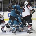 Arizona Coyotes defenseman Kevin Connauton, left, scores a goal against the San Jose Sharks during the first period of an NHL hockey game in San Jose, Calif., Tuesday, Feb. 13, 2018. (AP Photo/Jeff Chiu)